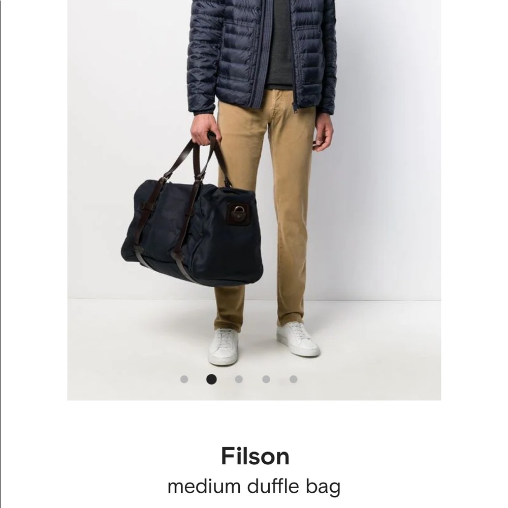 Filson Rugged Twill Medium Duffle Bag with leather bridle strap.